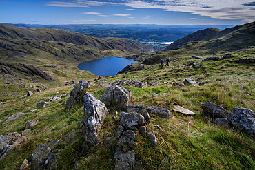 Walkers on Little How Crags above Levers Water on The Old Man of Coniston, Lake District National Park, UNESCO World Heritage Site, Cumbria, England, United Kingdom, Europe