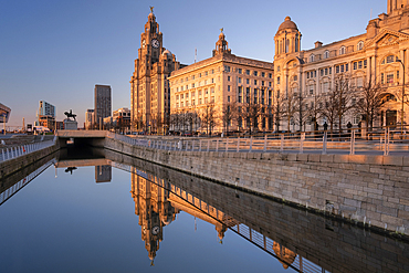 Evening light illuminates the Liver Building, the Cunard Building and Port of Liverpool Building (The Three Graces), Pier Head, Liverpool Waterfront, Liverpool, Merseyside, England, United Kingdom, Europe