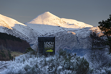 Loch Lomond and Trossachs National Park Signboard with Ben More and the Crianlarich Hills behind in winter, Loch Lomond and Trossachs National Park, Scottish Highlands, Scotland, United Kingdom, Europe