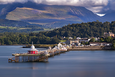 Bangor Pier and the Menai Strait backed by the Carneddau Mountains of Snowdonia or Eryri in summer, Anglesey, North Wales, UK