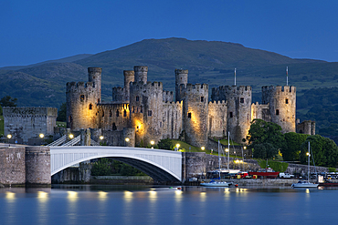 Conwy Castle (Welsh: Castell Conwy) across the River Conwy at night, Conwy, Conwy County Borough, North Wales, UK