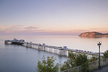 Llandudno Pier and the Little Orme from the Promenade at sunset, Llandudno, Conwy County Borough, North Wales, UK