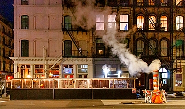 Steam emitted from the New York Steam System. Dating back to 1882 the system provides steam to heat, cool or disinfect some 1,700 buildings. Excess steam is vented from orange and white funnels known as stacks.