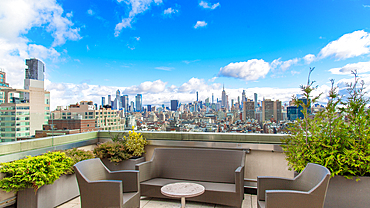 Roof top bar in Tribeca, New York City, USA, looking North towards Midtown and the Empire State Building.