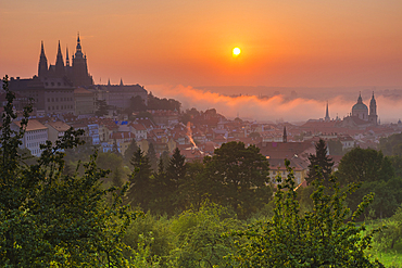 Prague Castle, St. Nicholas Church and gardens of Petrin Hill at sunrise, UNESCO World Heritage Site, Prague, Czechia, Europe