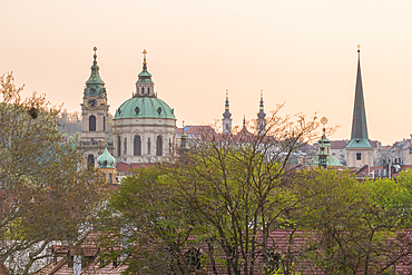 Tower and dome of St. Nicholas Church and St. Thomas Church in Lesser Town at sunset, Prague, Czech Republic (Czechia), Europe