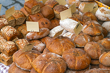 Different types of fresh bread on display at farmers market on Vltava riverside near Palackeho namesti, Prague, Czech Republic (Czechia), Europe