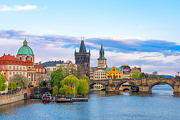 Charles Bridge and Church of Saint Francis of Assisi with Old Town Bridge Tower against sky at dusk, Prague, Czech Republic