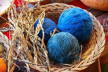 Blue balls of wool and dried plant as natural dye, Chinchero, Sacred Valley, Urubamba Province, Cusco (Cuzco) Region, Peru, South America