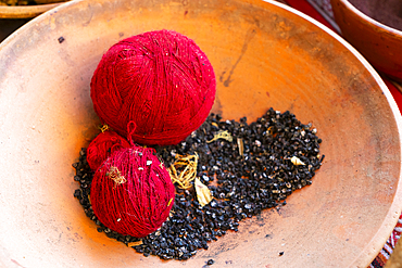 Red balls of wool and cactus insects as natural dye, Chinchero, Sacred Valley, Urubamba Province, Cusco (Cuzco) Region, Peru, South America