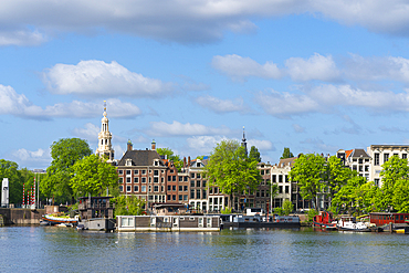 Houses by Oosterdok and Montelbaanstoren tower in background, Amsterdam, The Netherlands