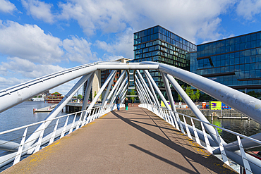 Man and woman walking on Mr. J.J. van der Veldebrug bridge, Amsterdam, The Netherlands