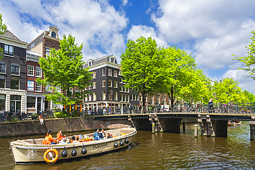 Tourist boat on Herengracht canal, Amsterdam, The Netherlands