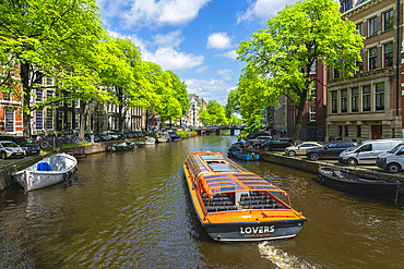 Tourist boat on Herengracht canal, Amsterdam, The Netherlands