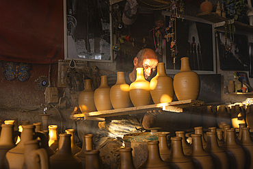 Master working at clay pottery workshop full of vases, Avanos, Cappadocia, Central Anatolia Region, Anatolia, Turkey, Asia Minor, Asia