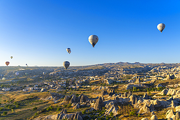 Aerial view of hot air balloons over rock formations at sunrise, Goreme, Goreme Historical National Park, UNESCO World Heritage Site, Cappadocia, Central Anatolia Region, Anatolia, Turkey, Asia Minor, Asia