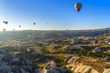 Aerial view of hot air balloons over rock formations at sunrise, Goreme, Goreme Historical National Park, UNESCO World Heritage Site, Cappadocia, Central Anatolia Region, Anatolia, Turkey, Asia Minor, Asia