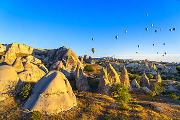 Aerial view of hot air balloons over rock formations at sunrise, Goreme, Goreme Historical National Park, UNESCO World Heritage Site, Cappadocia, Central Anatolia Region, Anatolia, Turkey, Asia Minor, Asia