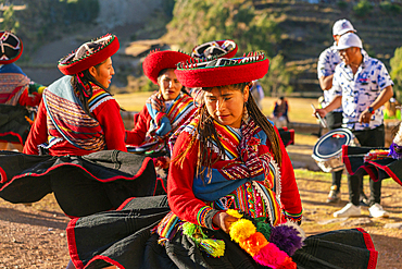 Peruvian women in traditional dresses dancing on celebration, Chinchero, Peru