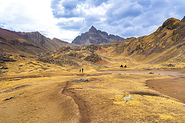 Hikers hiking in Andean mountains towards Rainbow mountain, Pitumarca District, Cuzco Region, Peru