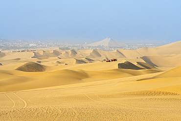 Dune buggies on sand dunes in desert, Huacachina, Ica District, Ica Province, Ica Region, Peru