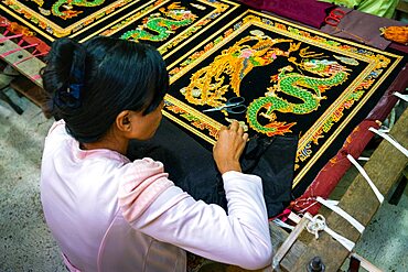 Woman embroidering ornaments at workshop, Mandalay, Myanmar