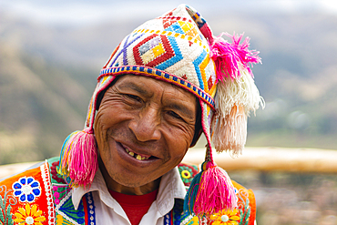 Smiling Peruvian man in colorful clothes, Sacred Valley, Cusco, Peru, South America