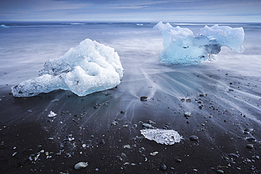 Chunks of ice washed by sea, Diamond beach near Jokulsarlon glacier lagoon, Iceland, Polar Regions