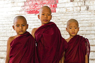 Three novice monks looking at camera, Mandalay Hill, Mandalay, Myanmar (Burma), Asia