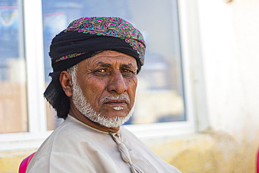 Portrait of Omani man with headwear looking at camera, Hasik, Dhofar Governorate, Oman, Middle East