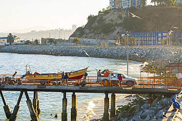 Boat being transported on pier at Caleta Portales, Valparaiso, Valparaiso Province, Valparaiso Region, Chile, South America