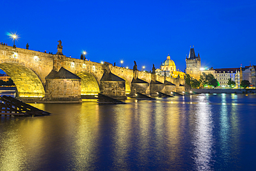 Illuminated Charles Bridge with reflections at twilight, UNESCO World Heritage Site, Prague, Bohemia, Czech Republic (Czechia), Europe