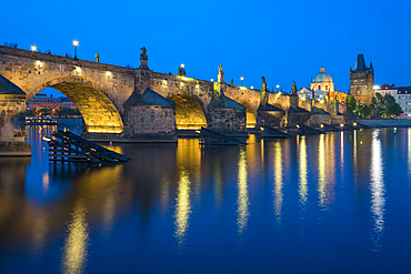 Illuminated Charles Bridge with reflections at twilight, UNESCO World Heritage Site, Prague, Bohemia, Czech Republic (Czechia), Europe