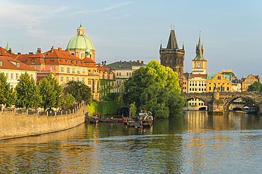 Charles Bridge and Church of Saint Francis of Assisi with Old Town Bridge Tower against sky, UNESCO World Heritage Site, Prague, Bohemia, Czech Republic (Czechia), Europe