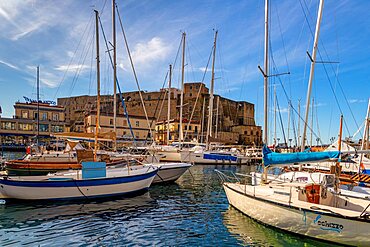 Small harbor with boats in front of the Castel dell'Ovo, Naples, Campania, Italy