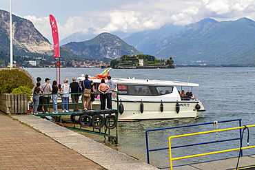Tourists queue to board motorboats for trips on the lake. Stresa, Lake Maggiore, Verbano Cusio Ossola discrict, Piedmont, Italy, Europe