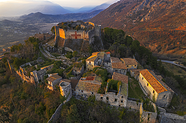 Aerial view of the medieval castle of Vicalvi, with red cross painted on the perimetral wall, overlooking the old village at sunset, Vicalvi, Frosinone province, Ciociaria, Latium region, Lazio, Italy, Europe