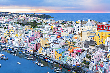 Elevated view of the colourful Italian fishing village of Marina Corricella at dusk, Procida island, Tyrrhenian Sea, Naples district, Naples Bay, Campania region, Italy, Europe