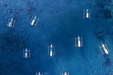 Aeria view of traditional empty fishing boats in the blue water of Gili Trawangan, Gili Islands, West Nusa Tenggara, Pacific Ocean, Indonesia, Southeast Asia Asia