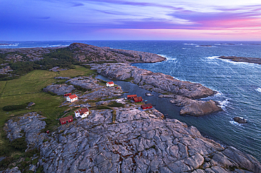 Aerial view of the scenic landscape of granite rocks with isolated houses and red cottages along the shore, Ramsvik island, Bohuslan, Vastra Gotaland, West Sweden, Sweden, Scandinavia, Europe