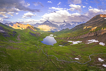 Panoramic aerial view of Bachalpsee with clouds surrounding the Bernese Oberland mountains, Grindelwald, Bern canton, Switzerland, Europe