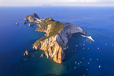 Aerial view of the island of Palmarola, with boats anchored in the blue waters of Brigantina bay, Palmarola island, Ponza municipality, Tyrrhenian Sea, Pontine islands, Latina Province, Latium (Lazio), Italy, Europe