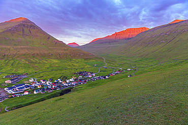 Early morning on Gjogv village with the mountain peaks lit by the sun, Eysturoy island, Faroe islands, Denmark, Europe