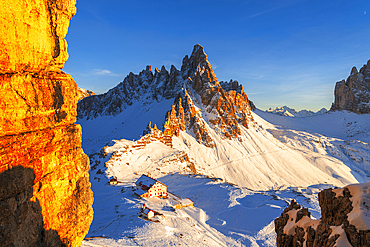 Winter sunset on Paterno mountain and Locatelli hut covered with snow, Tre Cime di Lavaredo (Lavaredo peaks), Sesto (Sexten), Dolomites, South Tyrol, Italy, Europe