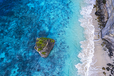 Aerial view of Suwehan white sandy beach with turquoise sea water and the big rock (sea stack) in the sea seen from a drone, Nusa Penida, Klungkung regency, Bali, Indonesia, Southeast Asia, Asia