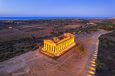 The illuminated Temple of Concordia seen from a drone at dawn, Valley of the Temples, UNESCO World Heritage Site, Agrigento, Sicily, Italy, Mediterranean, Europe