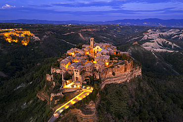 Aerial view of the medieval village of Civita di Bagnoregio lit at dusk, Viterbo province, Latium, Italy, Europe