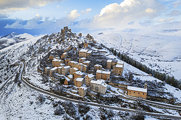 Aerial winter view of the snow covered medieval village of Rocca Calascio with the castle surrounded by clouds at dusk, Rocca Calascio, Gran Sasso e Monti della Laga National Park, Campo Imperatore, L'Aquila province, Abruzzo region, Italy, Europe