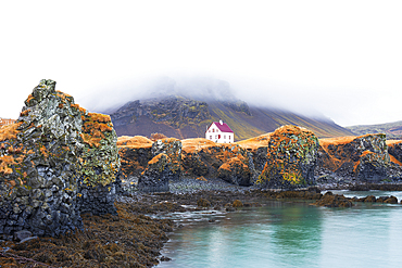 Lonely house above the basalt cliff near the harbour, Arnarstapi, Snaefellsjokull National Park, Snaefellsness peninsula, Vesturland, Western Iceland, Iceland, Polar Regions