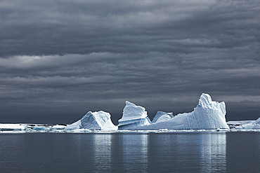 Icebergs with dark skies, Antarctica, Polar Regions